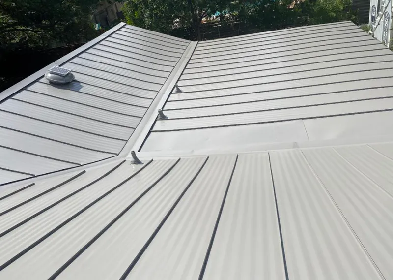 Solar attic fan installed on a metal roof for Roof Ventilation in Siler City